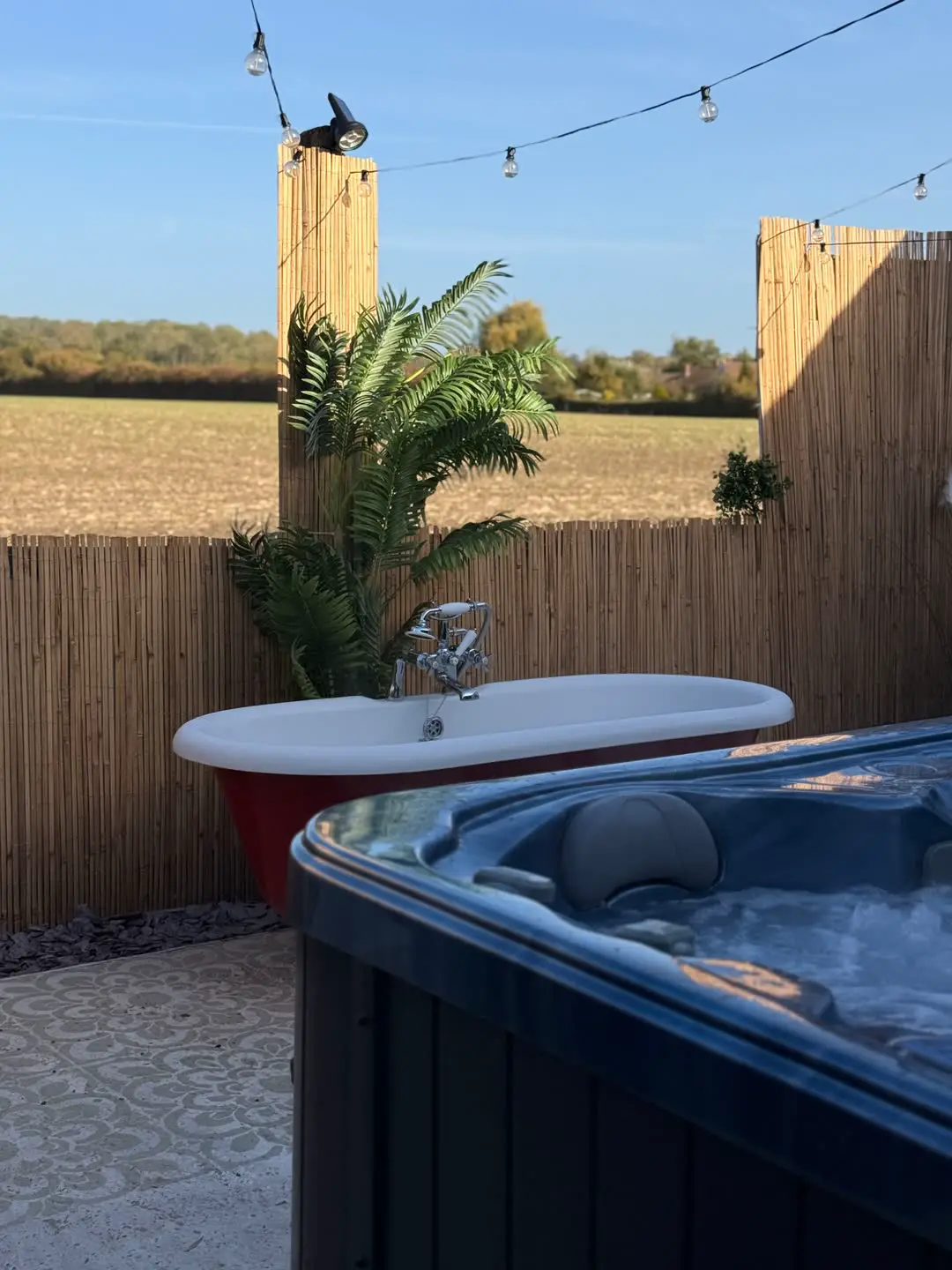 Hot tub and outdoor bath at Fabulook Wellness Studio, Arrington, looking over the Cambridgeshire fields